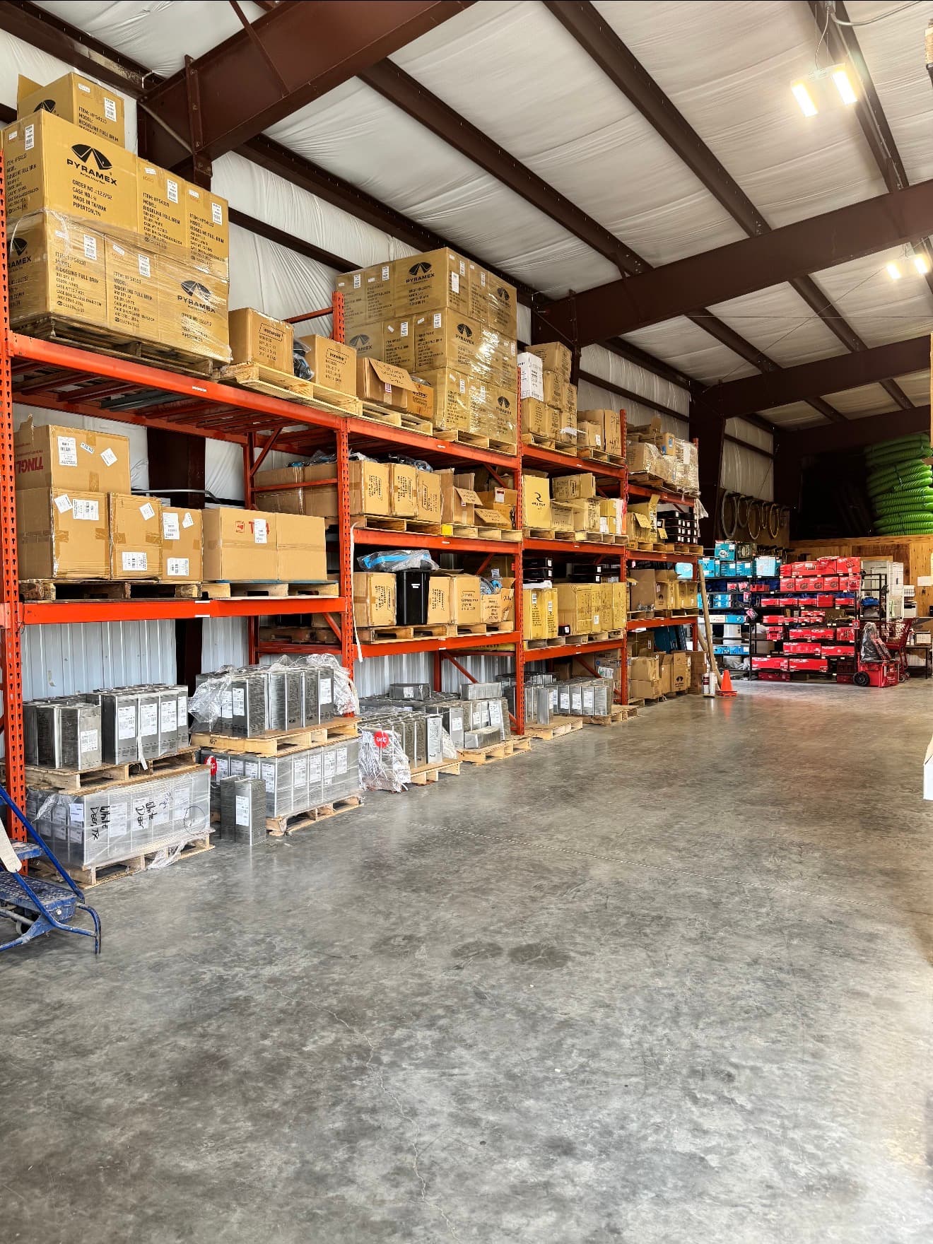 Warehouse aisle with palletized inventory and product shelving