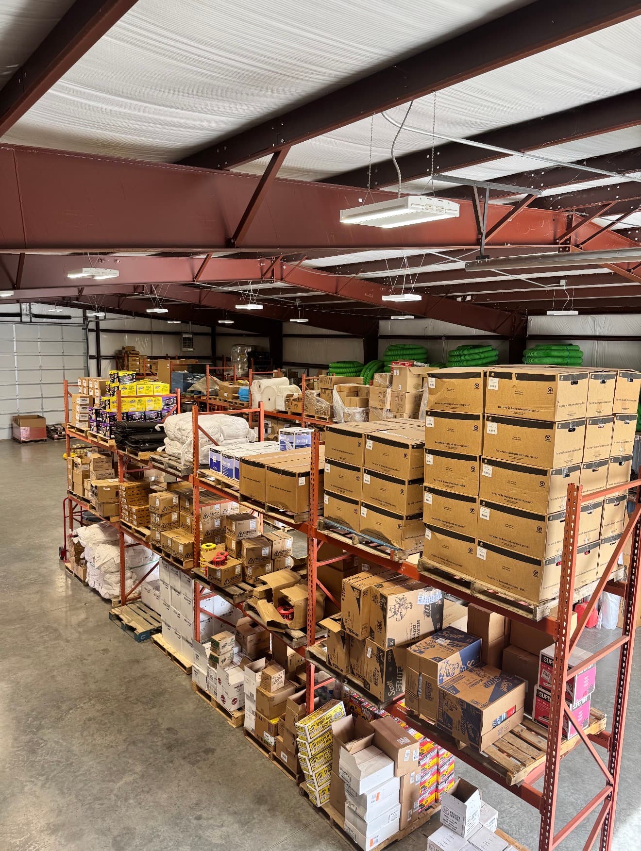 Warehouse overview showing stocked shelves and industrial materials
